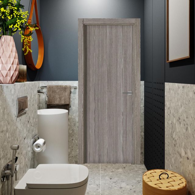 Puerta laminada G1000 Zenic perciber instalada en baño moderno con paredes gris cemento y elementos decorativos.