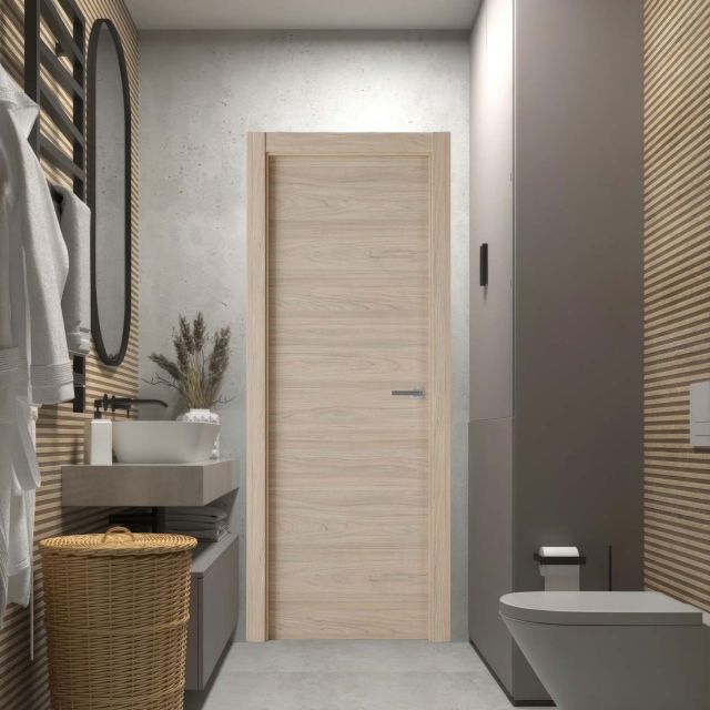 Puerta laminada modelo X1000 en color Roble Estrío instalada en un baño moderno, diseño Perciber.